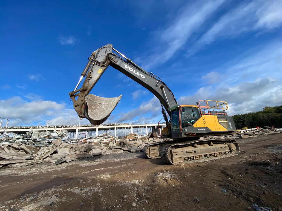 Volvo excavator breaking out concrete slab at Goliath Warehouse